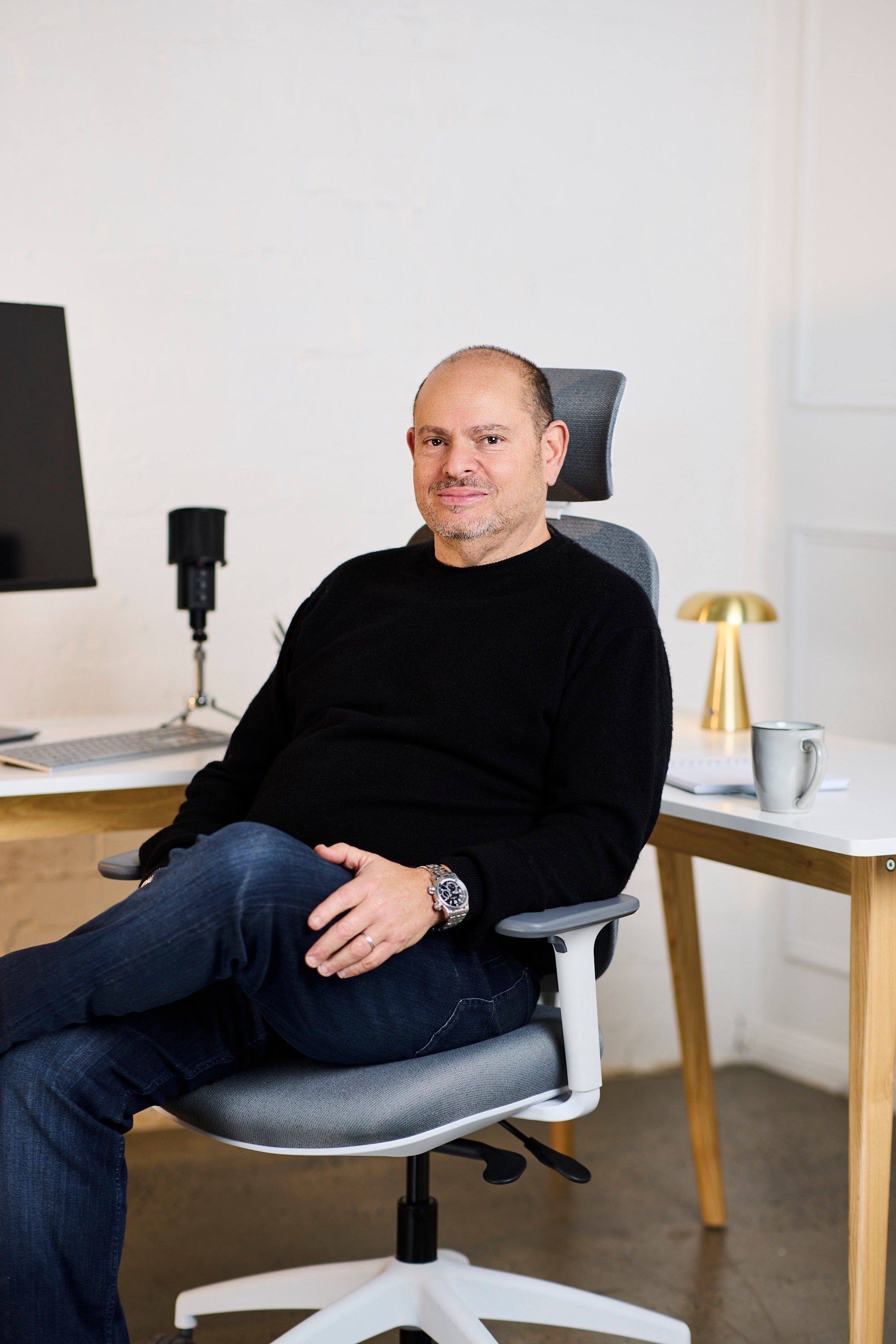 Paul Goldberg seated in an office chair